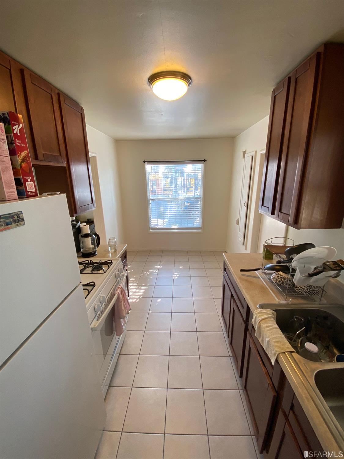 2127-2143 Dwight Way Berkeley, CA 94704 - Photo 24 of 39 a kitchen with a stove and a refrigerator
