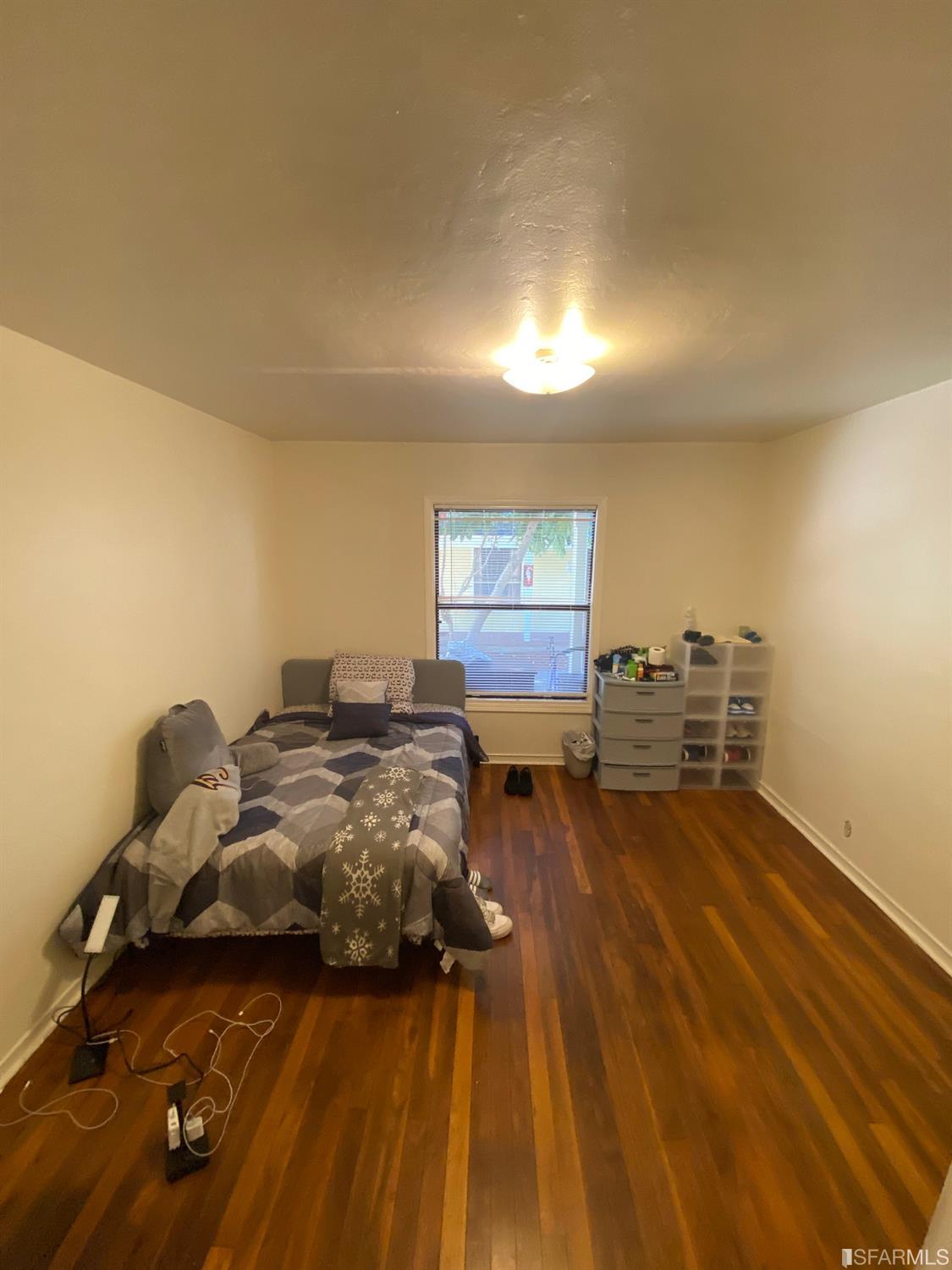 2127-2143 Dwight Way Berkeley, CA 94704 - Photo 35 of 39 a living room with furniture and a wooden floor