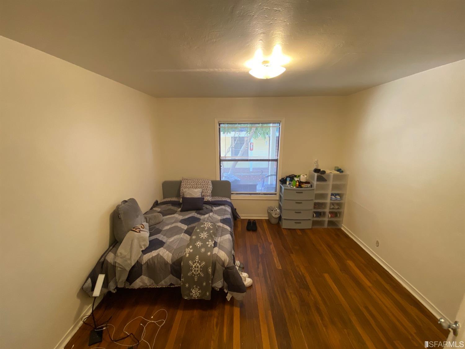 2127-2143 Dwight Way Berkeley, CA 94704 - Photo 36 of 39 a bed room with a bed and a chair