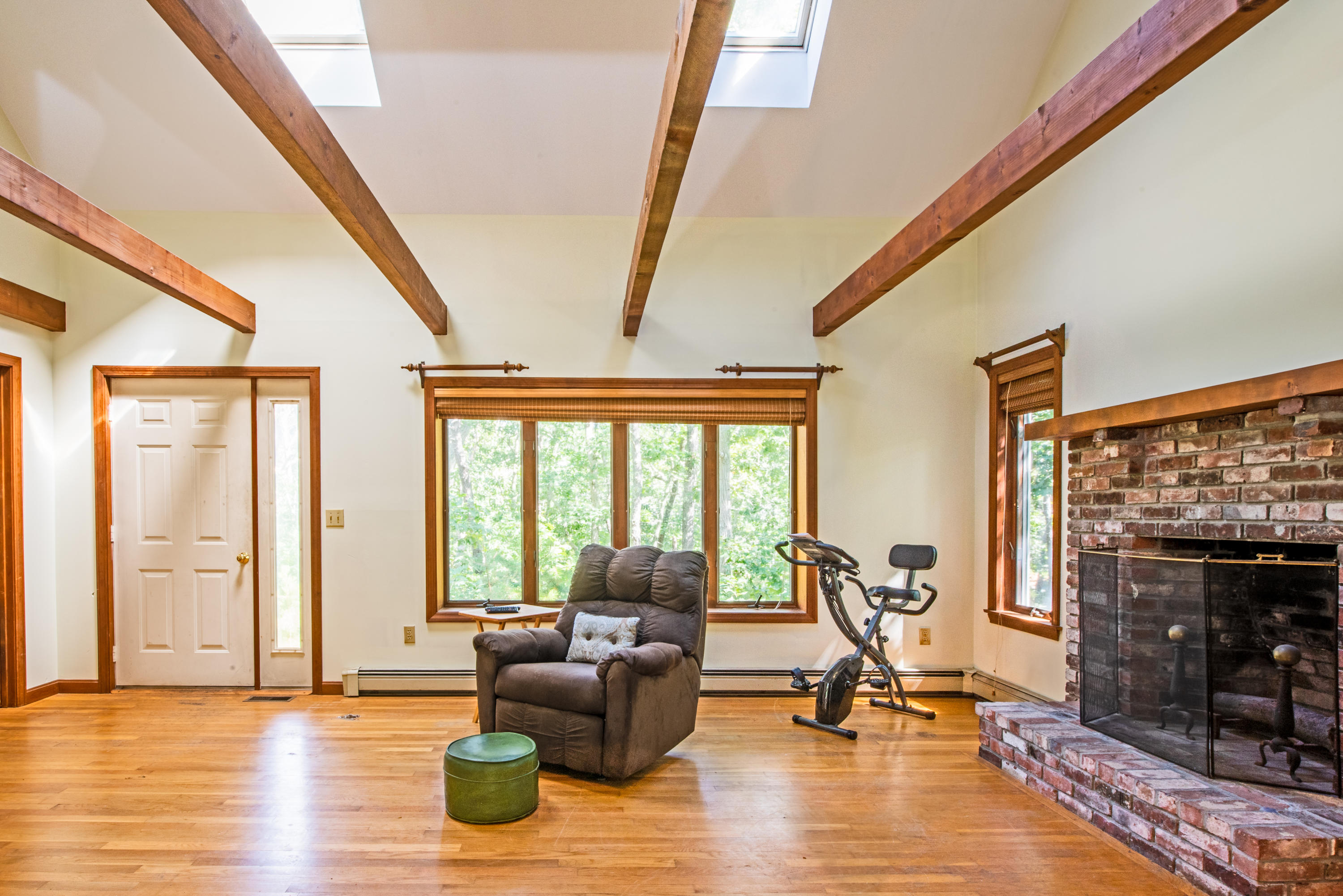 35 Oak Valley Road Wellfleet, MA 02667 - Photo 4 of 15 a living room with furniture windows and a fireplace