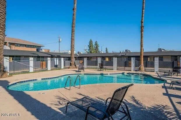 a view of a house with backyard and sitting area
