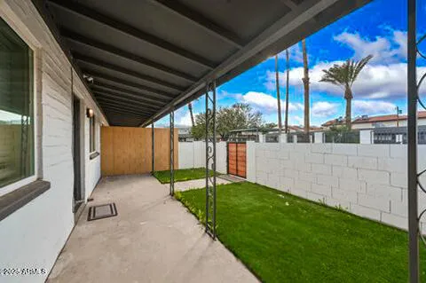 a kitchen with granite countertop a refrigerator a sink dishwasher a stove and white countertops with wooden floor