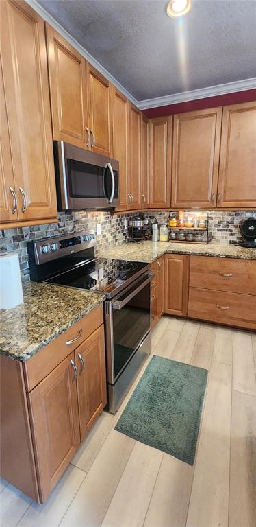 6839 Southwest 82 Terrace Gainesville, FL 32608 - Photo 15 of 28 a kitchen with stainless steel appliances granite countertop a stove a sink and a microwave