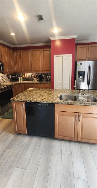 6839 Southwest 82 Terrace Gainesville, FL 32608 - Photo 16 of 28 a large kitchen with granite countertop a sink a counter space and cabinets