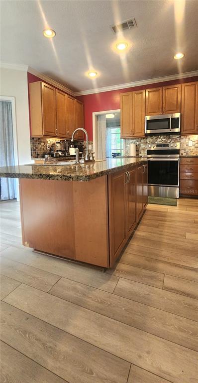 6839 Southwest 82 Terrace Gainesville, FL 32608 - Photo 18 of 28 a kitchen with stainless steel appliances granite countertop a stove a sink and a refrigerator