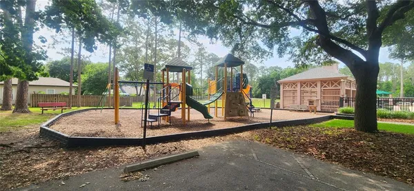 a view of a park with iron fence
