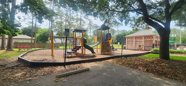 a view of a park with iron fence