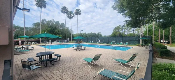 a swimming pool with outdoor seating and yard