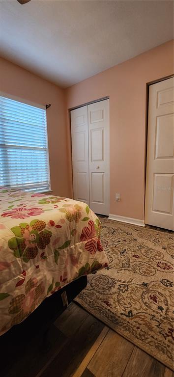 6839 Southwest 82 Terrace Gainesville, FL 32608 - Photo 27 of 28 a bedroom with a bed