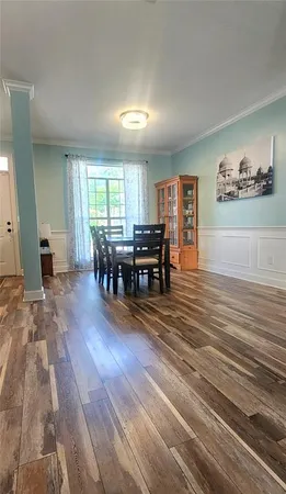 a view of a dining room with furniture window and wooden floor
