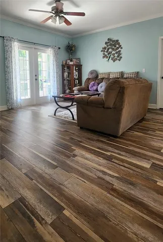 a living room with furniture and a wooden floor