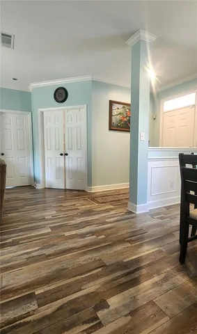 a view of a livingroom with wooden floor and cabinet