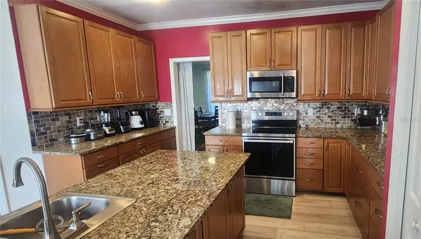 a kitchen with a stove a sink and a microwave