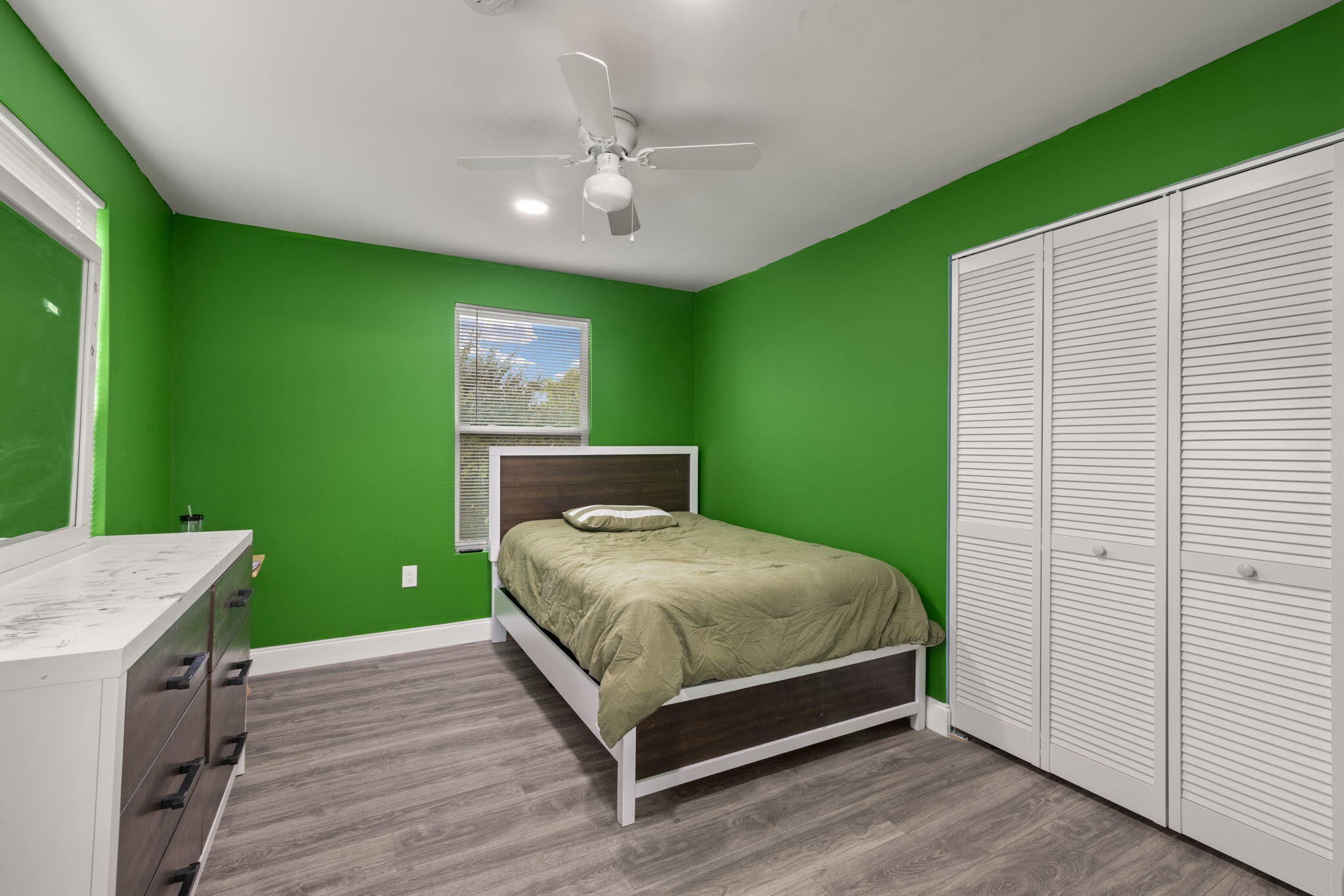337 East Obispo Avenue Clewiston, FL 33440 - Photo 11 of 19 a bedroom with a bed and a chandelier