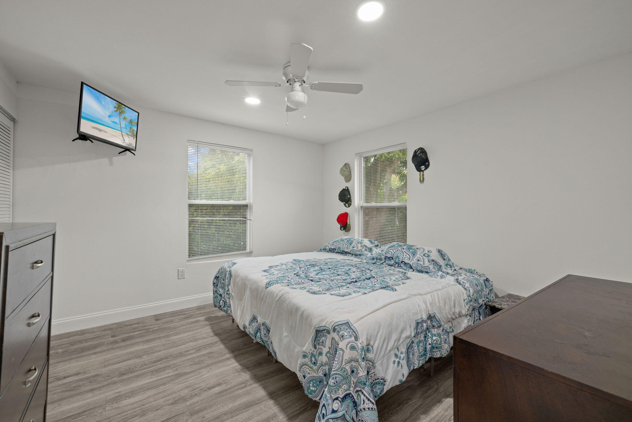 337 East Obispo Avenue Clewiston, FL 33440 - Photo 15 of 19 a bedroom with a bed and a chandelier
