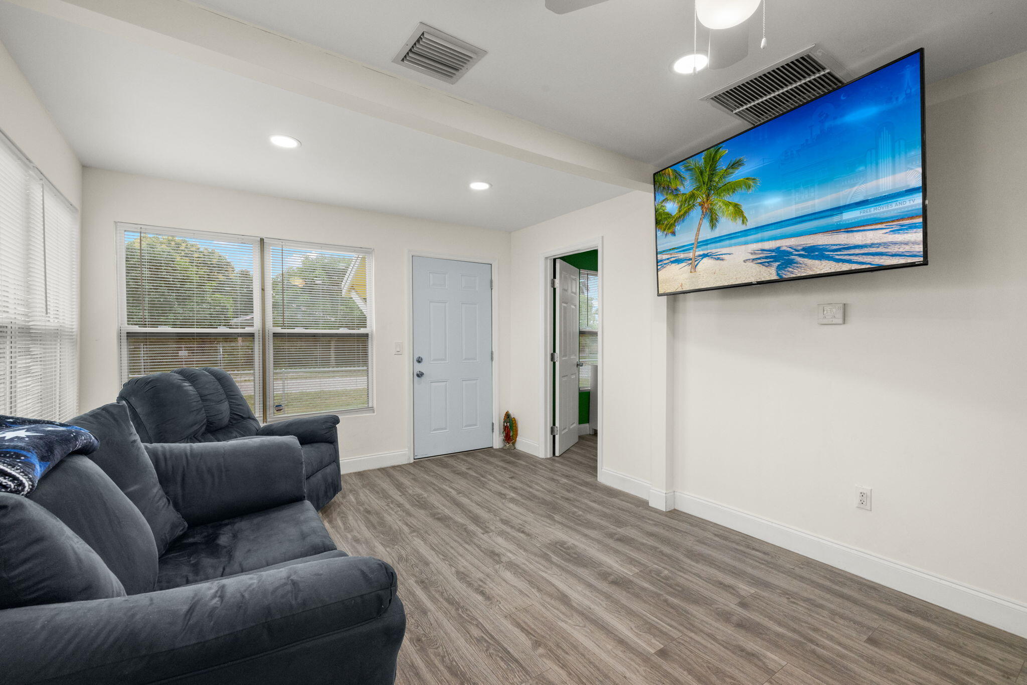 337 East Obispo Avenue Clewiston, FL 33440 - Photo 5 of 19 a living room with furniture and a floor to ceiling window