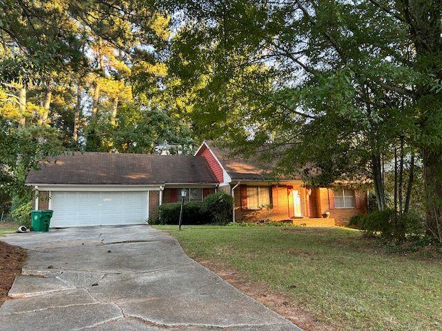 4183 Port Chester Way Decatur, GA 30034 - Photo 1 of 1 a front view of a house with a yard and a garage