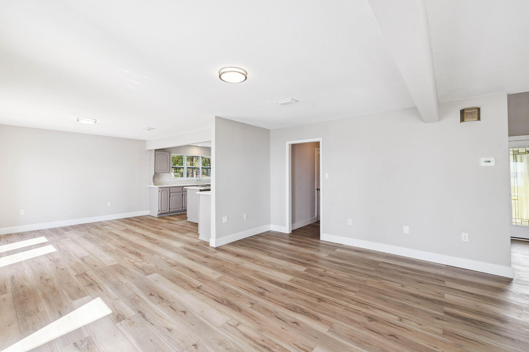 2208 Bay Grove Road Freeport, FL 32439 - Photo 11 of 70 a view of an empty room with wooden floor