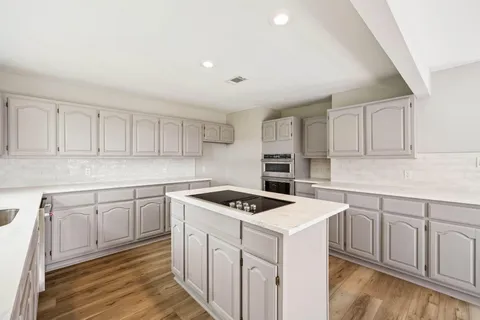 a view of swimming pool with large trees and a big yard