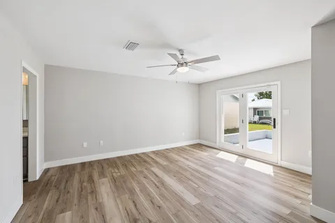 a view of an empty room with wooden floor