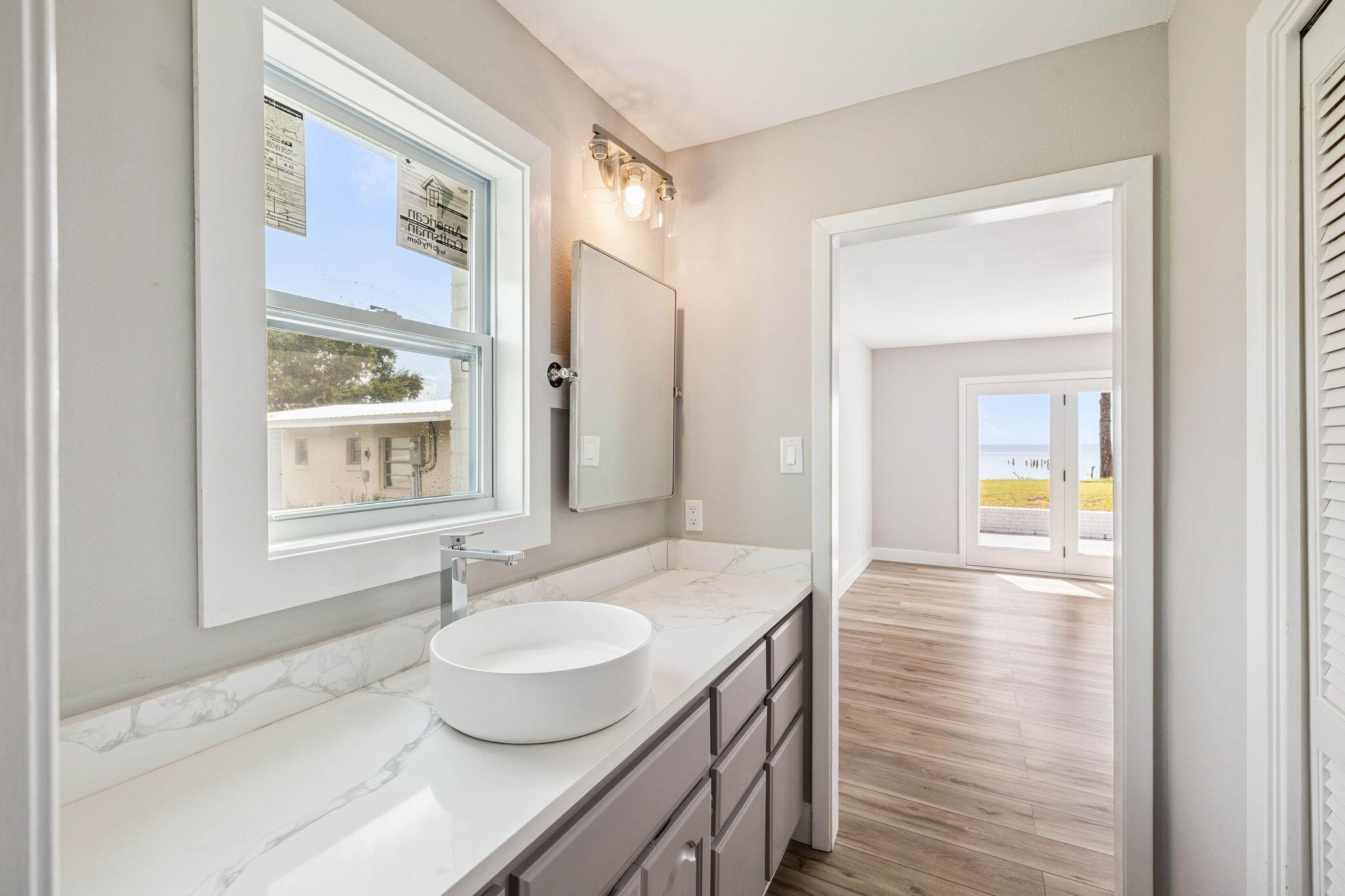 2208 Bay Grove Road Freeport, FL 32439 - Photo 39 of 70 a bathroom with a granite countertop sink and a mirror