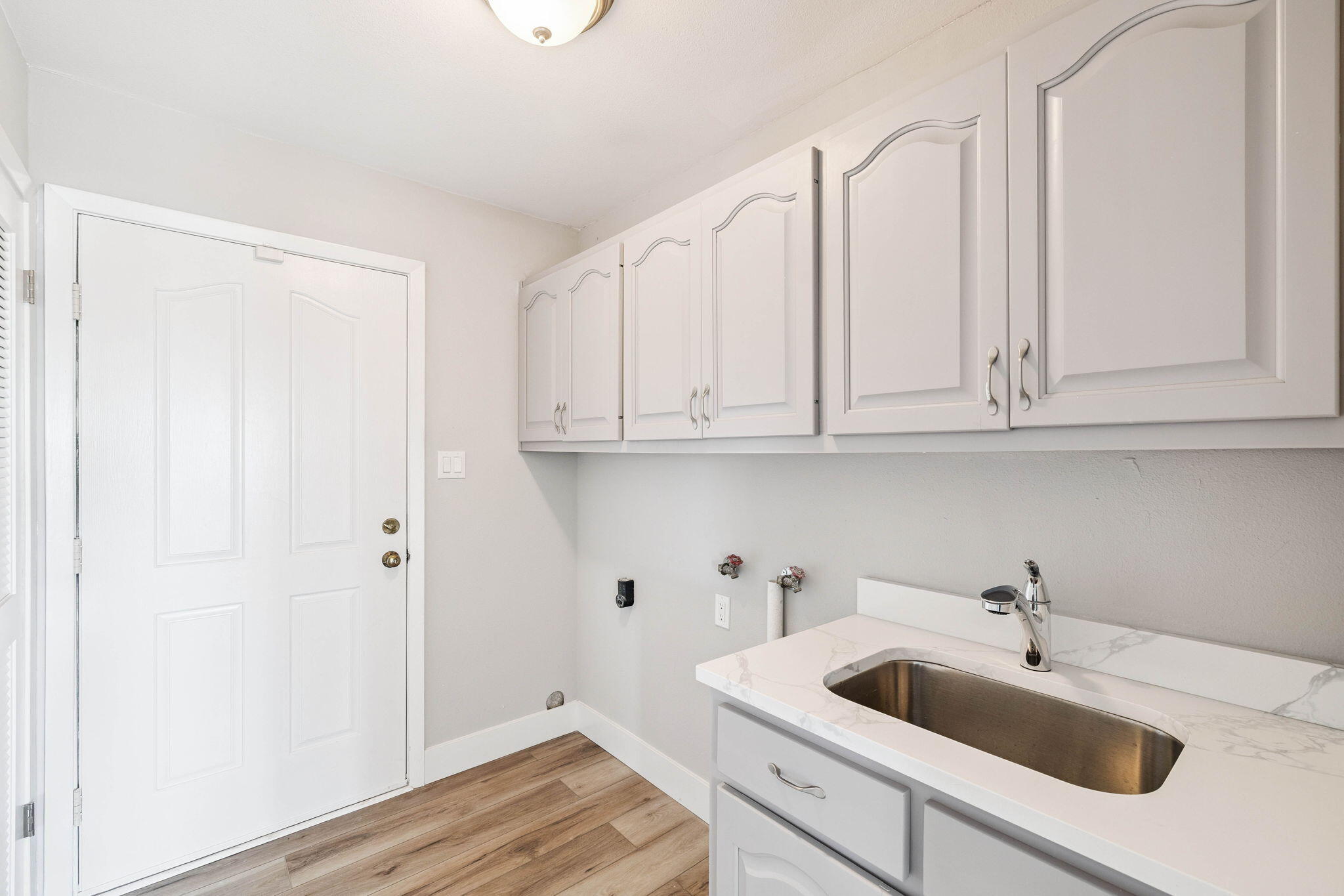2208 Bay Grove Road Freeport, FL 32439 - Photo 43 of 70 a kitchen with white cabinets and sink