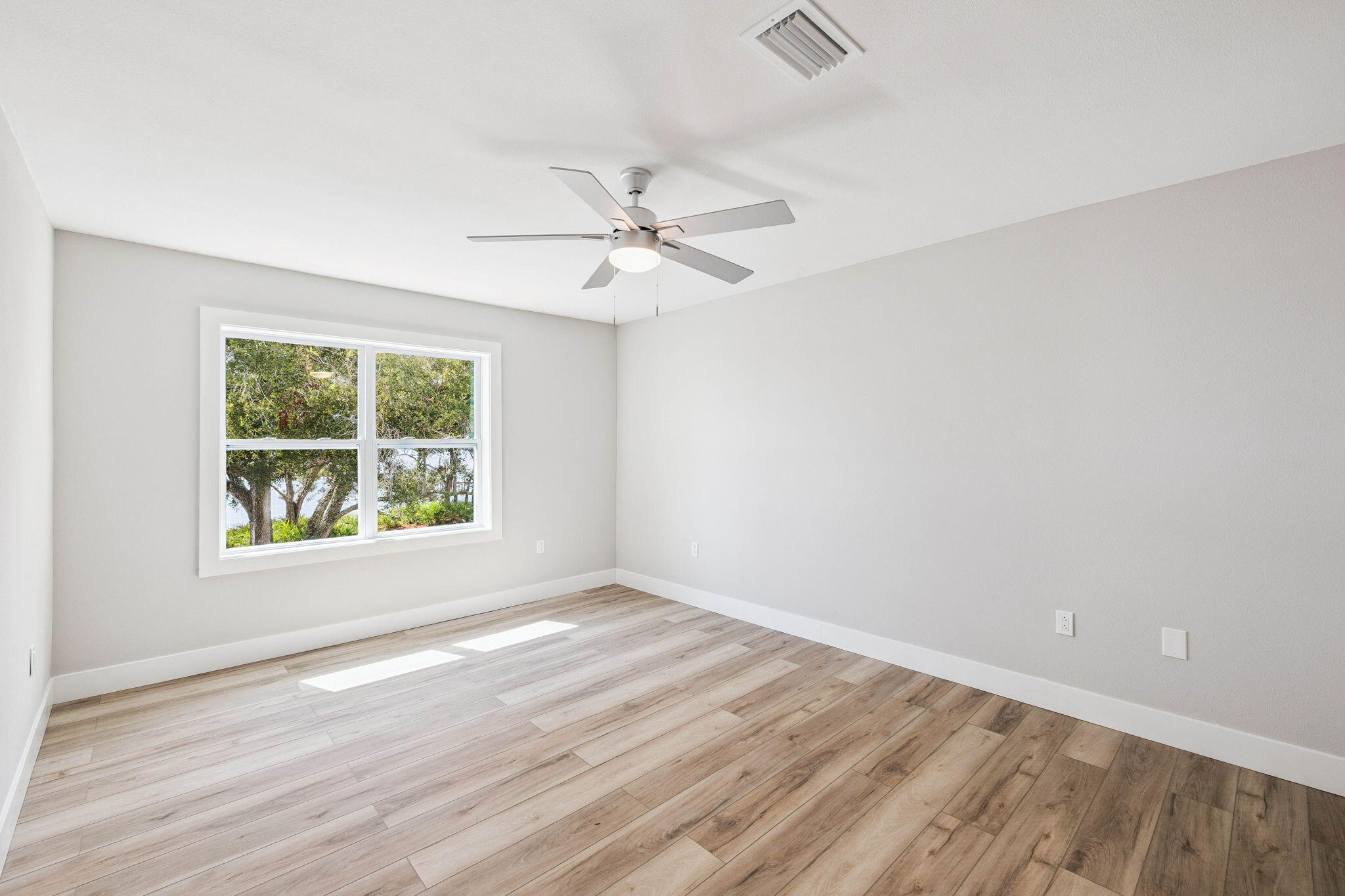 2208 Bay Grove Road Freeport, FL 32439 - Photo 55 of 70 an empty room with wooden floor and windows