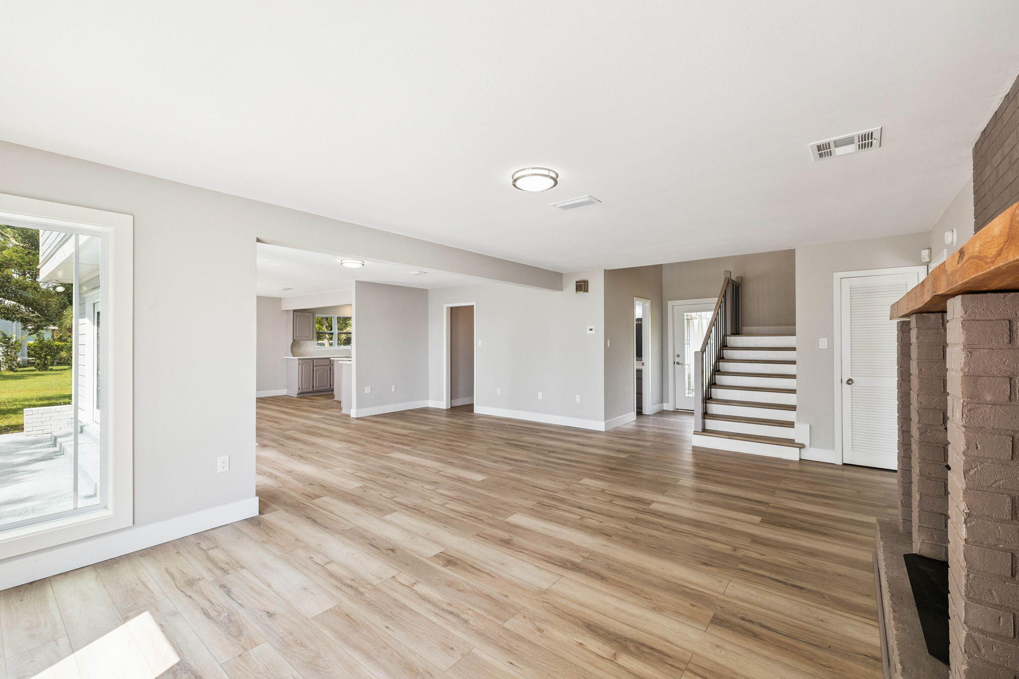 2208 Bay Grove Road Freeport, FL 32439 - Photo 6 of 70 a view of a livingroom with wooden floor and stairs
