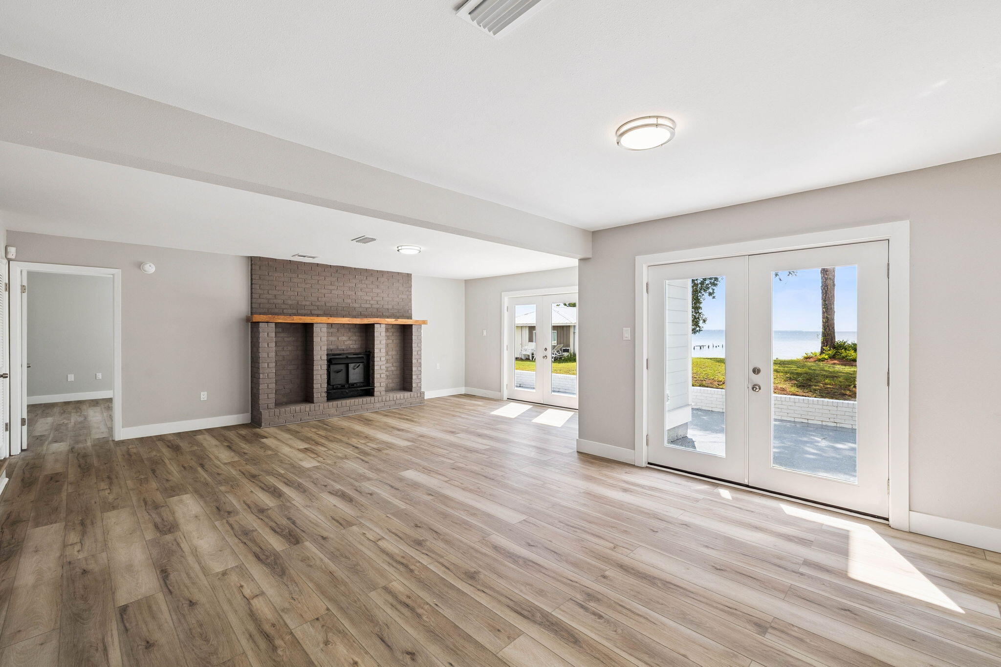 2208 Bay Grove Road Freeport, FL 32439 - Photo 8 of 70 a view of empty room with wooden floor and fireplace