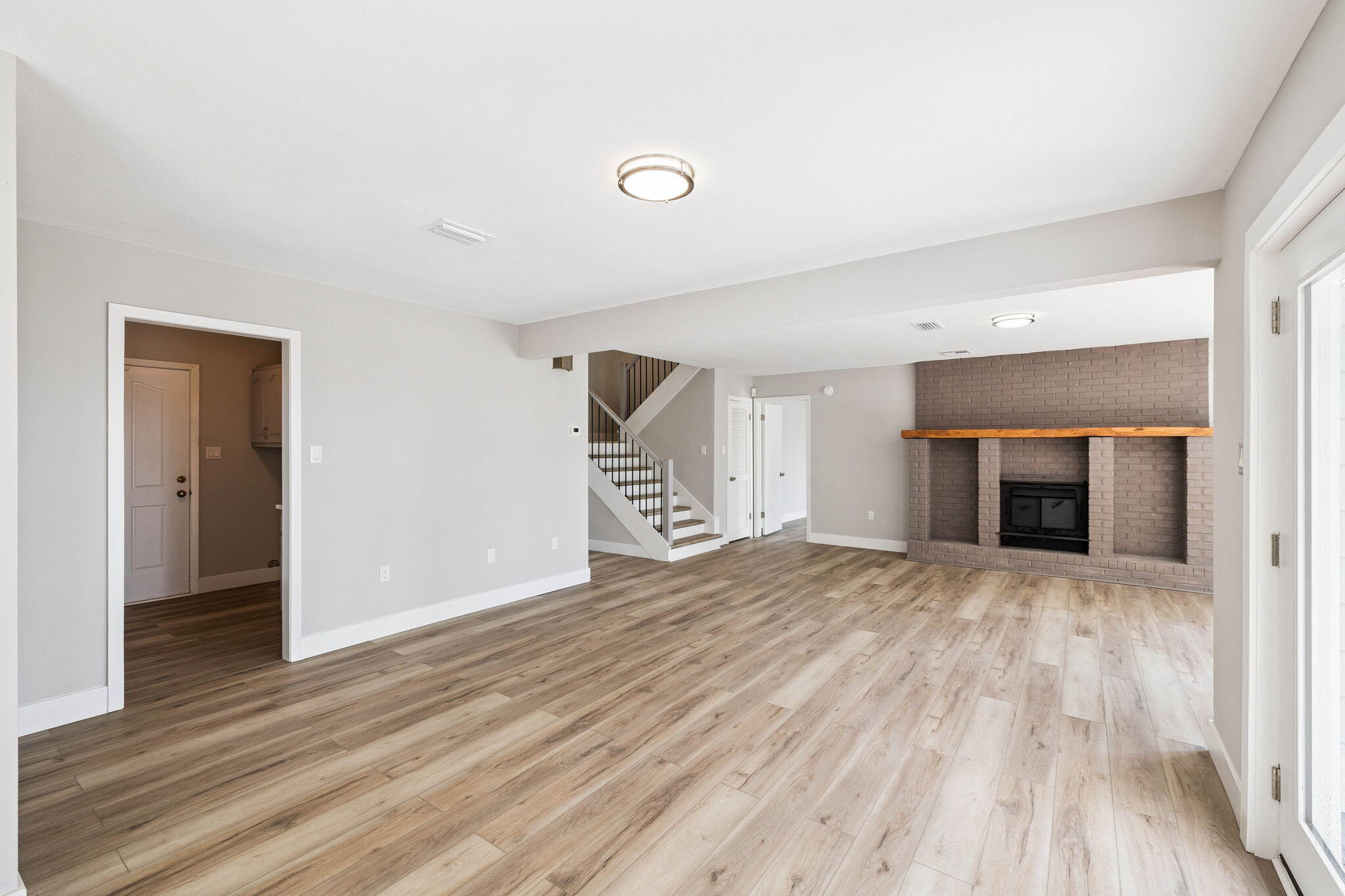 2208 Bay Grove Road Freeport, FL 32439 - Photo 10 of 70 a view of empty room with wooden floor and fireplace