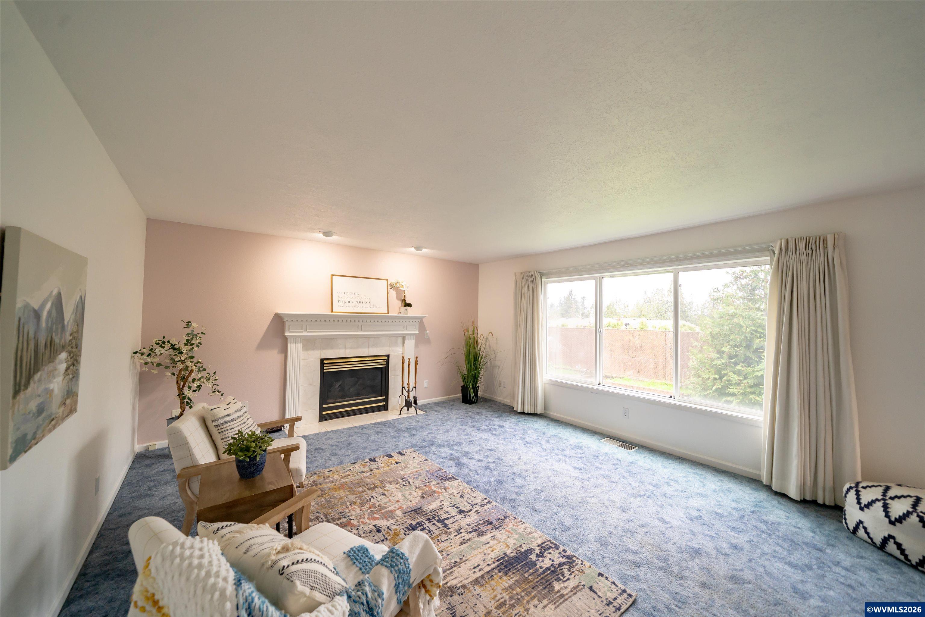 312 Southwest Cascade Meadow Drive Sublimity, OR 97385 - Photo 7 of 42 a living room with furniture and a fireplace