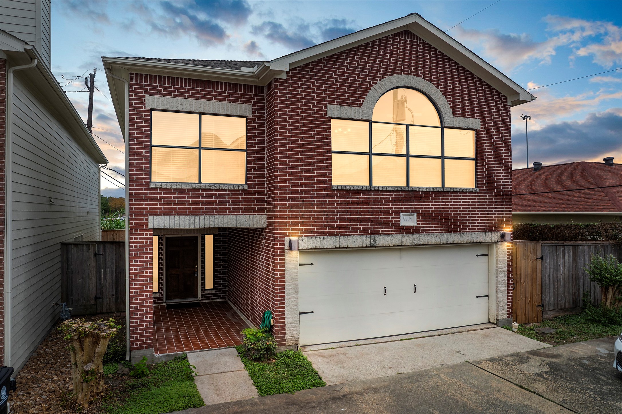 a front view of a house with a garden