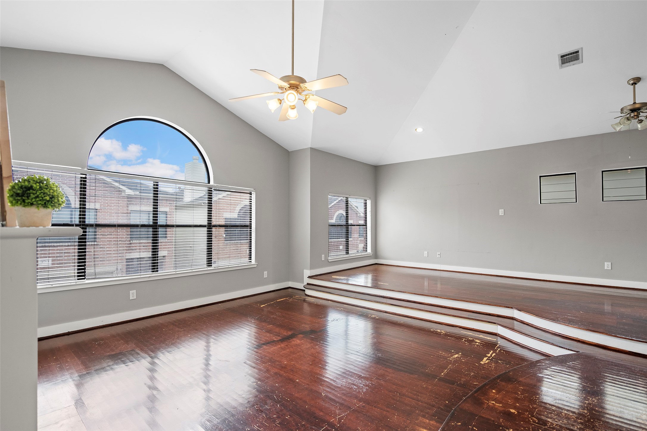 9705 Linkmeadow Lane Houston, TX 77025 - Photo 17 of 32 a view of an empty room with a window and wooden floor