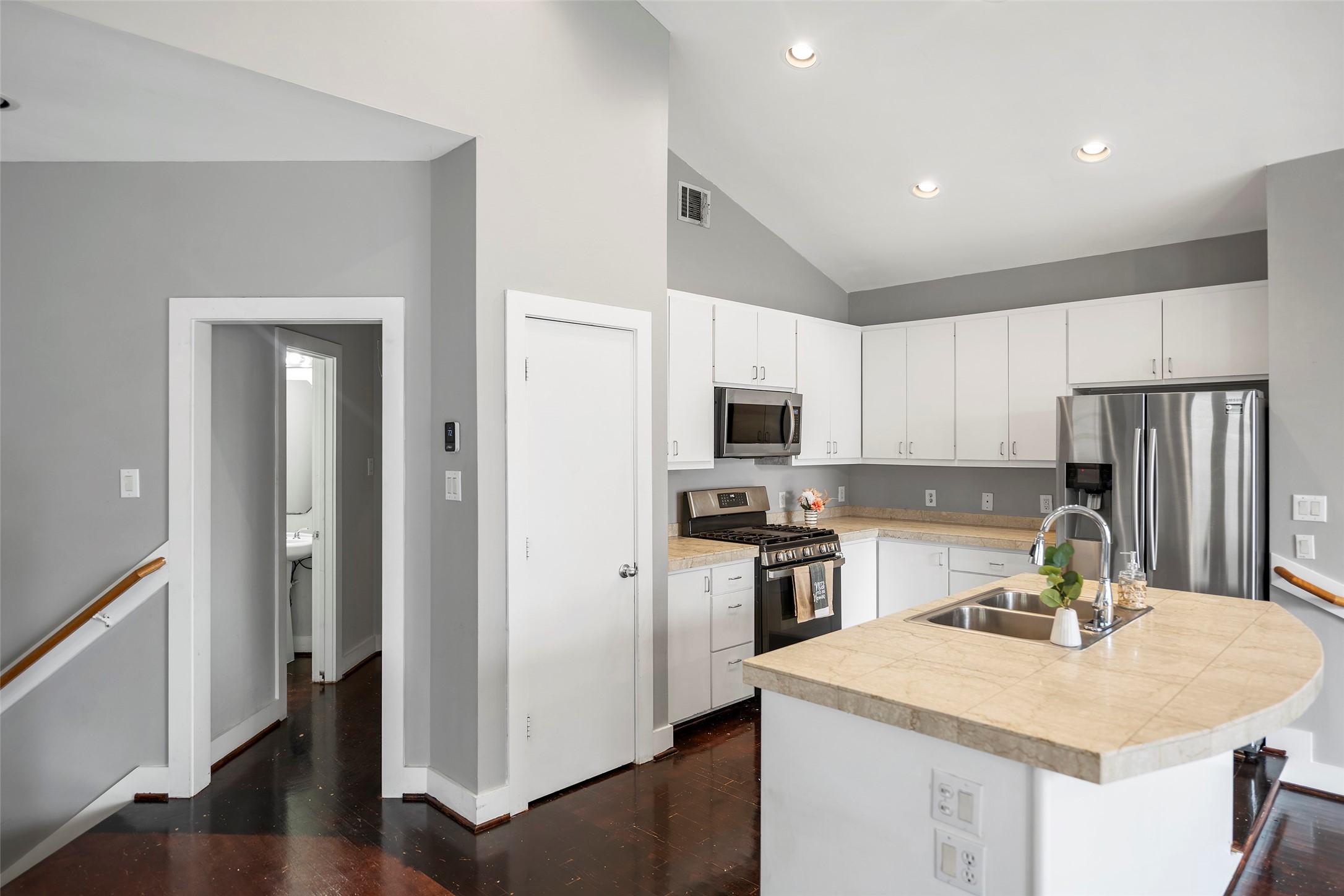 9705 Linkmeadow Lane Houston, TX 77025 - Photo 21 of 32 a kitchen with stainless steel appliances granite countertop a sink stove refrigerator and cabinets