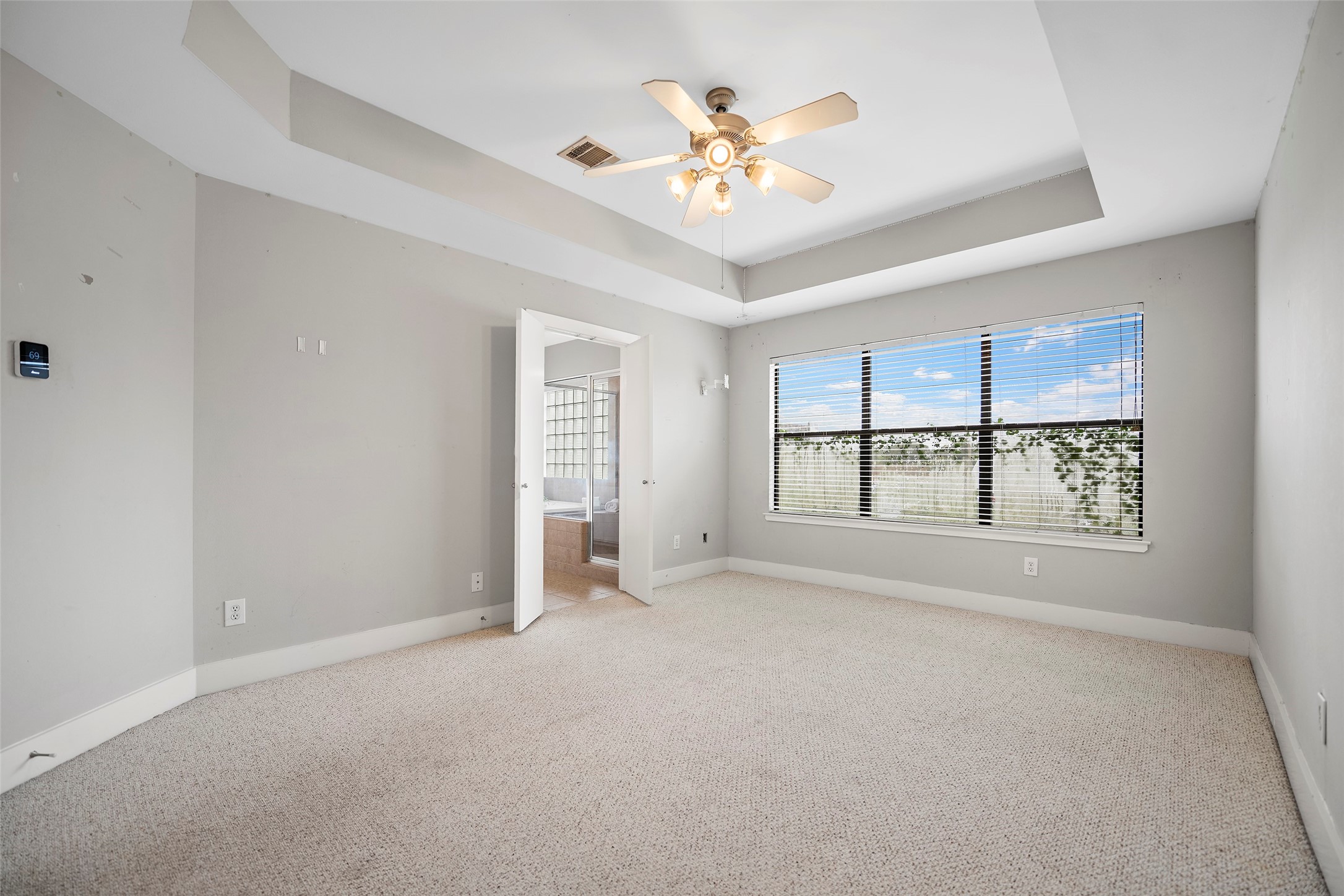9705 Linkmeadow Lane Houston, TX 77025 - Photo 24 of 32 an empty room with windows and chandelier fan