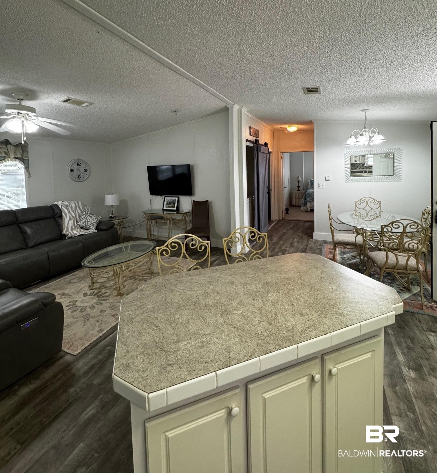 1351 Caney Loop Lillian, AL 36549 - Photo 35 of 35 Kitchen featuring open floor plan, dark wood-style floors, cream cabinetry, a ceiling fan, and a textured ceiling