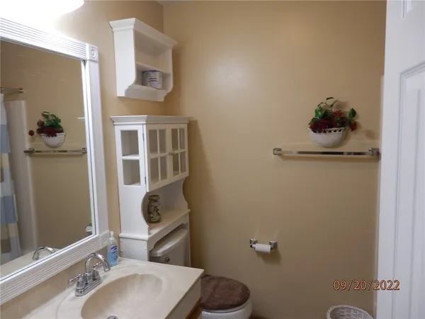 a bathroom with a toilet sink and mirror