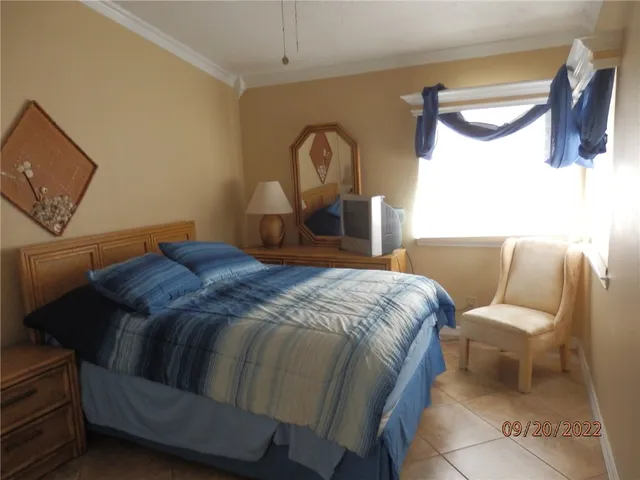 a bed sitting in a bedroom next to a lamp