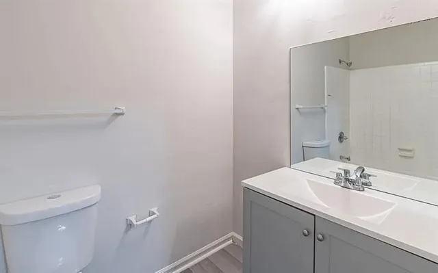 a bathroom with a sink toilet and a mirror
