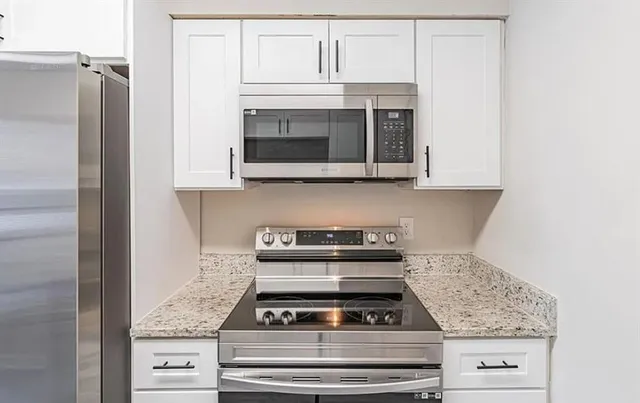 a stove top oven sitting inside of a kitchen