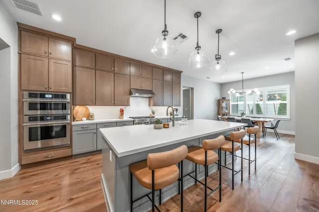 a large kitchen with a table and chairs