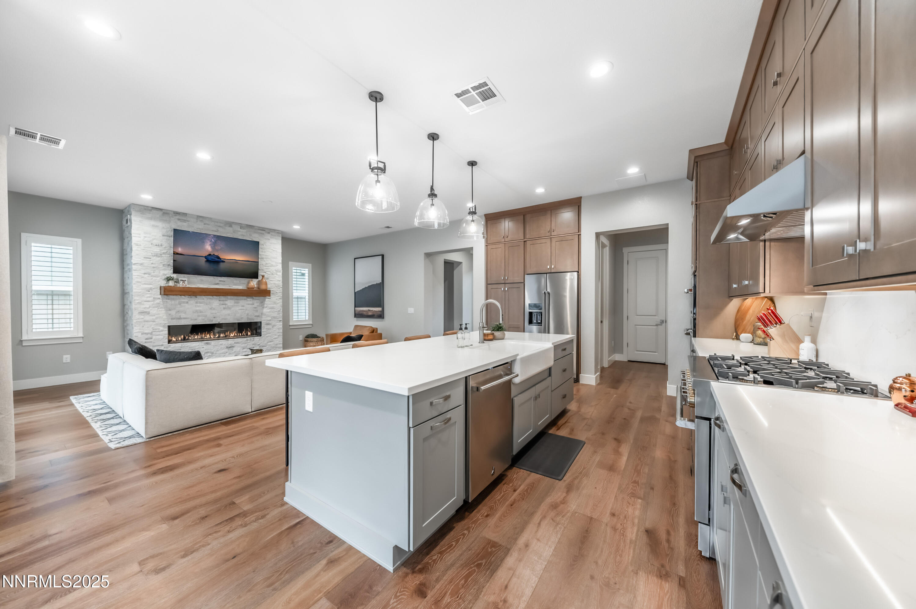 5453 Side Saddle Trail Reno, NV 89511 - Photo 13 of 33 a large kitchen with stainless steel appliances kitchen island granite countertop a large stove a refrigerator a oven and a view of living room