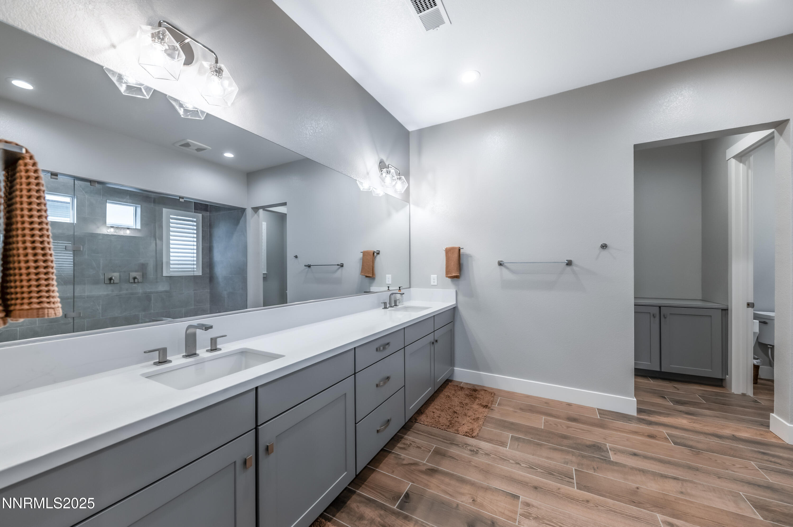 5453 Side Saddle Trail Reno, NV 89511 - Photo 16 of 33 a spacious bathroom with a double vanity sink and a mirror