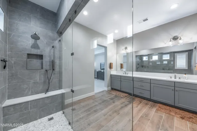 a large bathroom with a large tub shower and sink