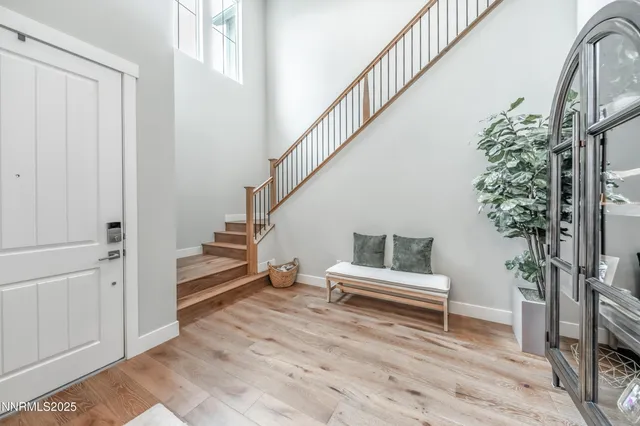 a view of entryway and hall with wooden floor