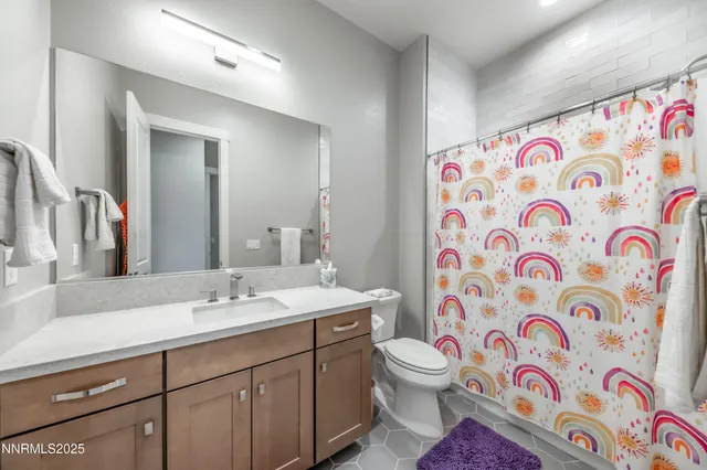 a spacious bathroom with a sink mirror vanity and toilet