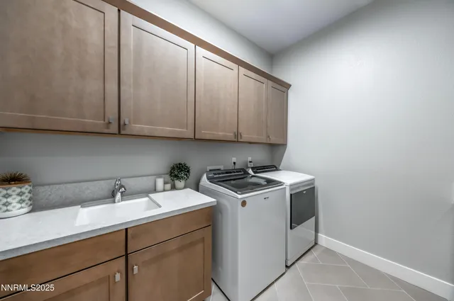 a utility room with sink dryer and washer