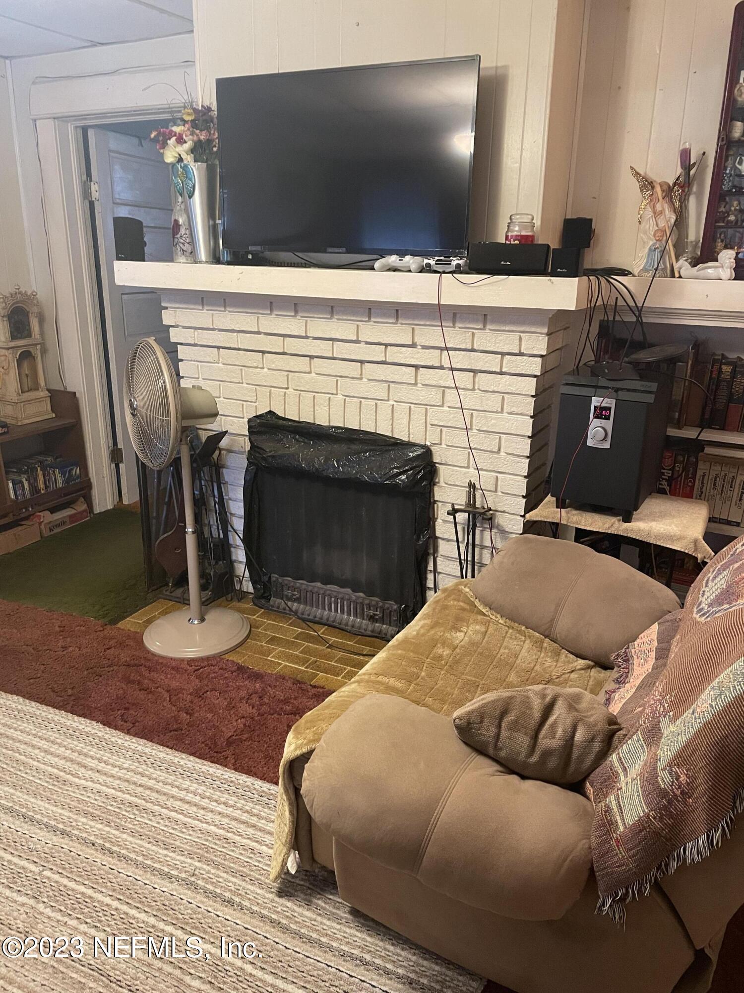 51 East 17th Street Jacksonville, FL 32206 - Photo 4 of 14 a bedroom with a bed and a fireplace