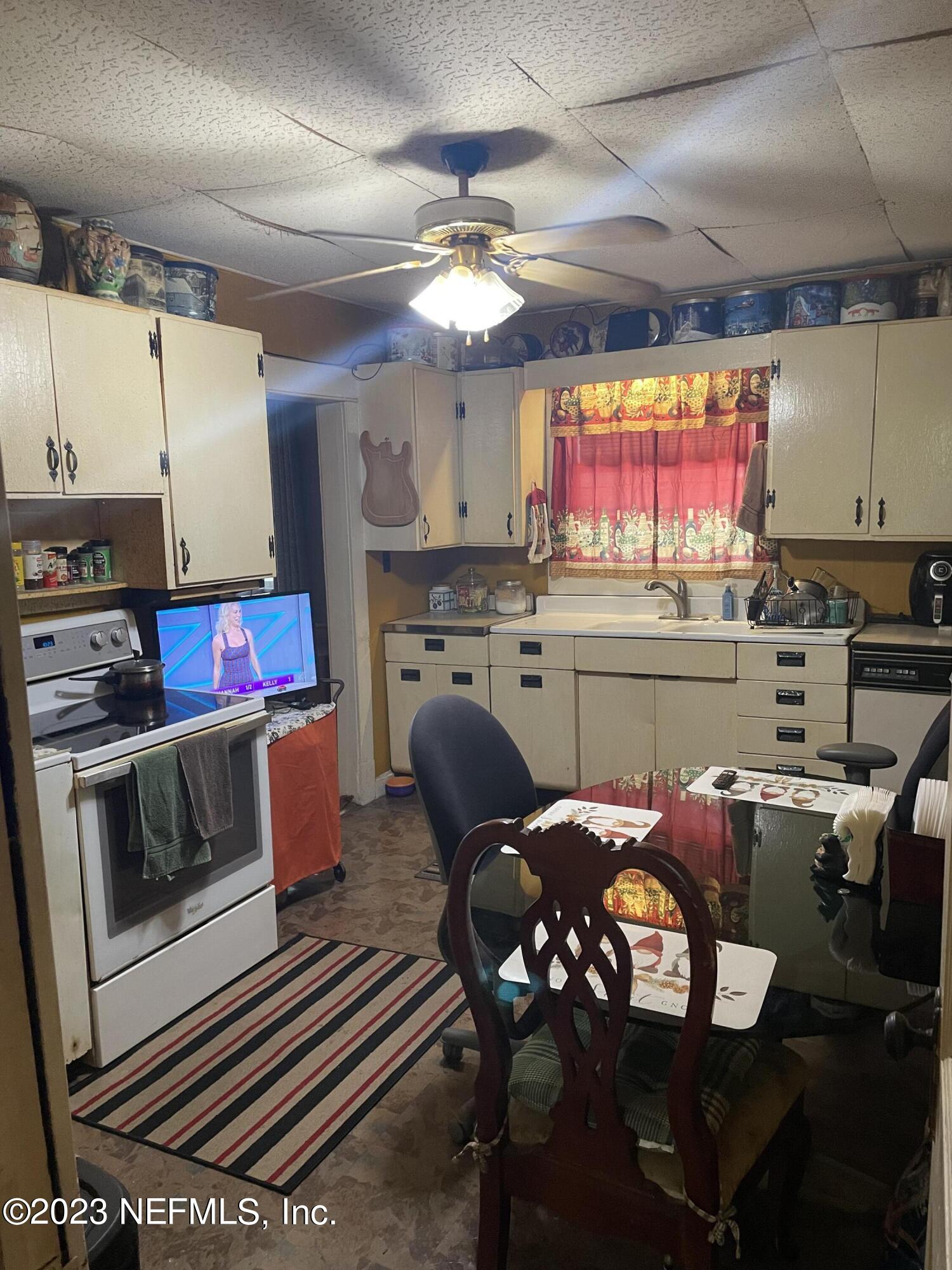 51 East 17th Street Jacksonville, FL 32206 - Photo 10 of 14 a kitchen with stainless steel appliances a stove a sink cabinets and a dining table