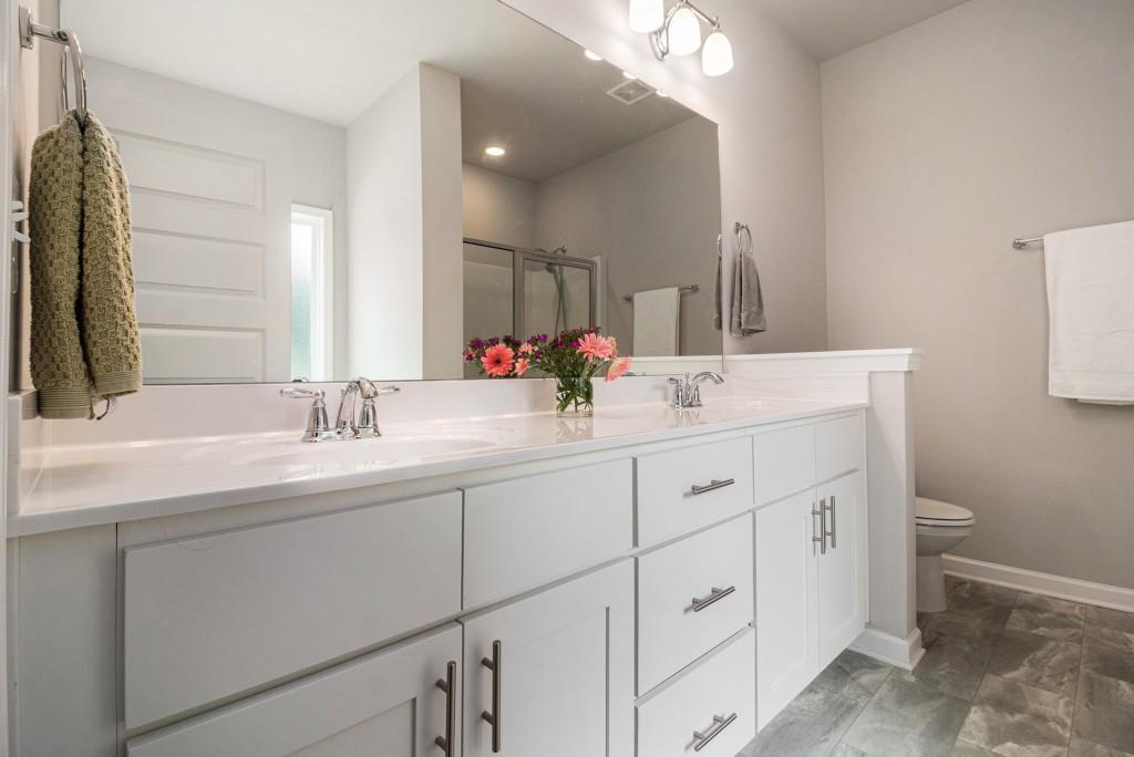 124 Willington Way Newnan, GA 30265 - Photo 16 of 41 a bathroom with double sink and a mirror